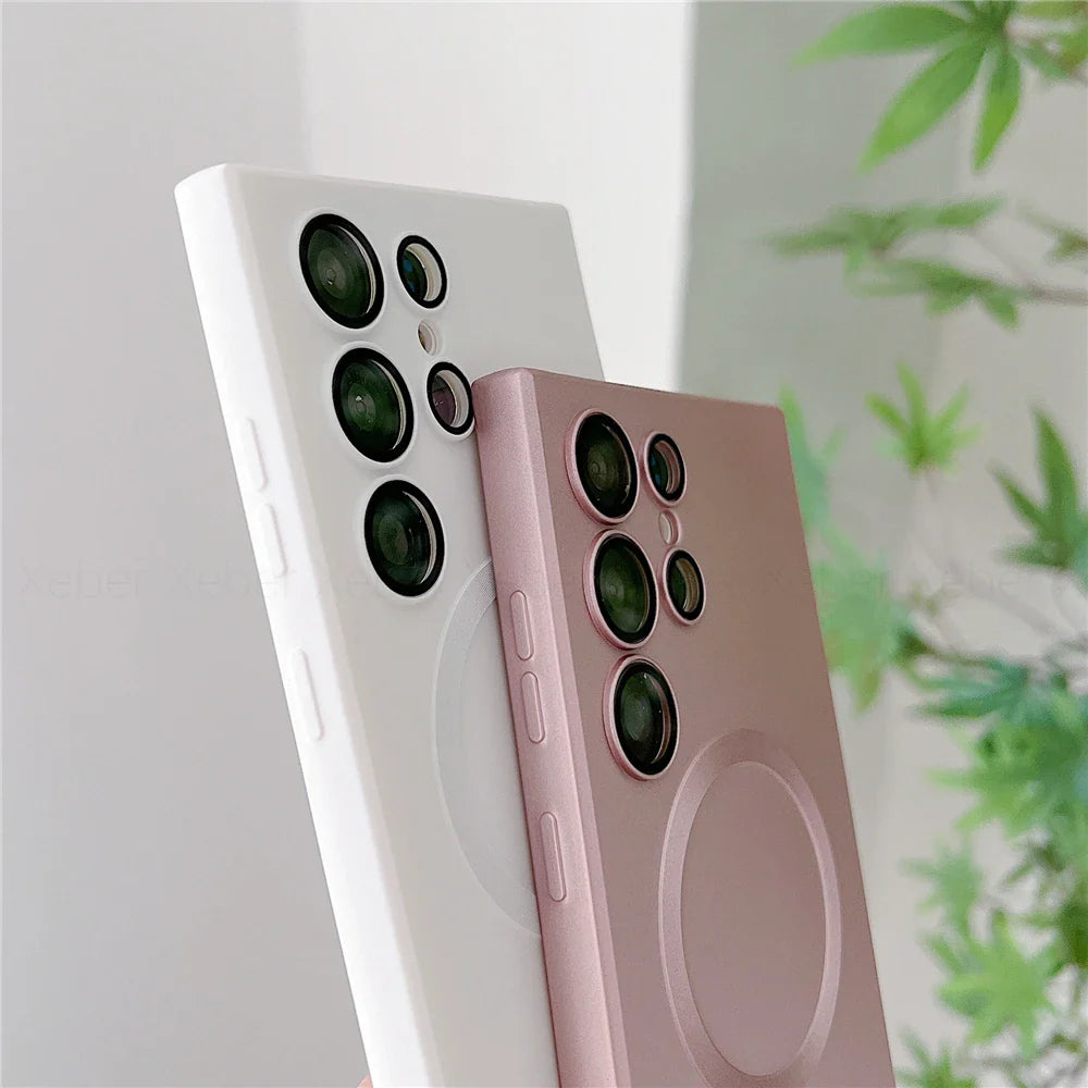 Two smartphones, one white and one pink, with multiple camera lenses and a circular magnetic accessory on the back.