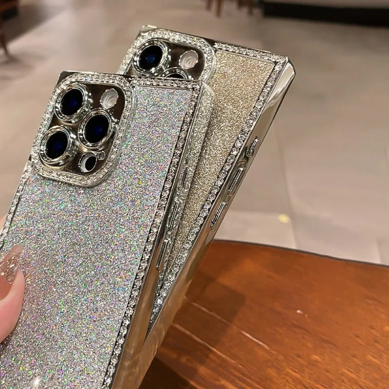 Two sparkly silver iPhone cases with diamond-encrusted camera cutouts and side bezels.