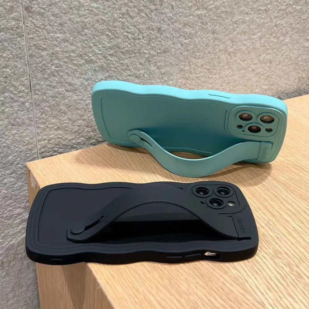 Two wavy-edged phone cases with attached hand straps.