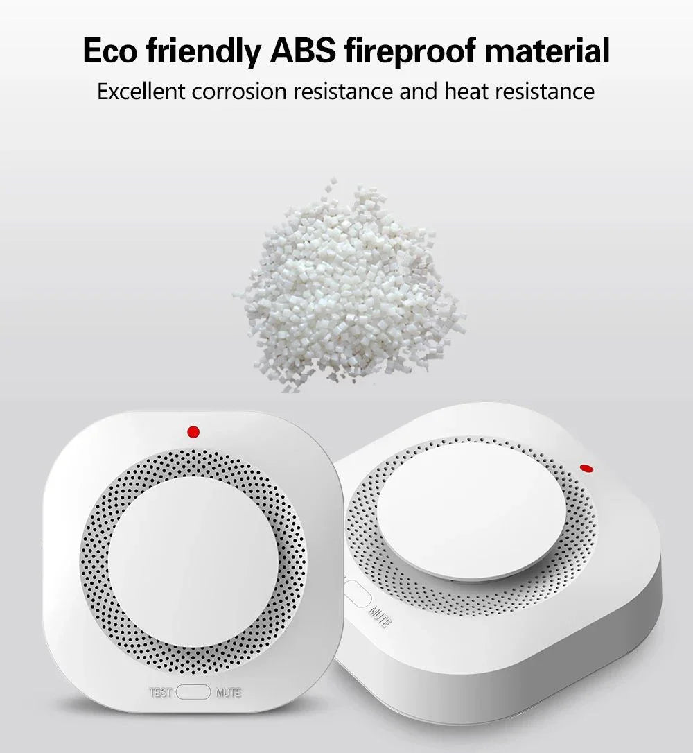 Two white smoke detectors and a pile of white plastic pellets.