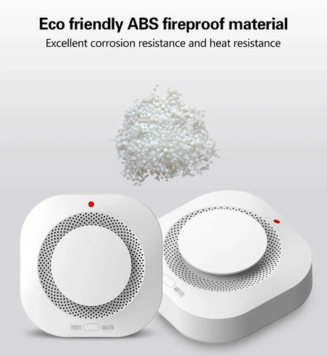 Two white smoke detectors and a pile of white plastic pellets.