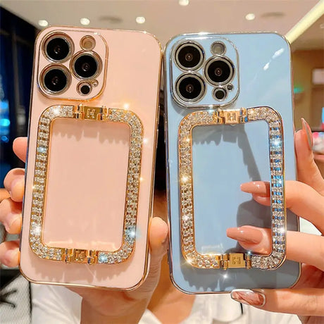 two women holding up their cell cases with diamonds