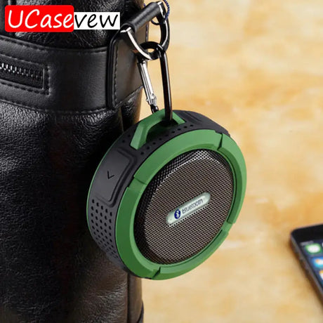 a green speaker with a black leather bag