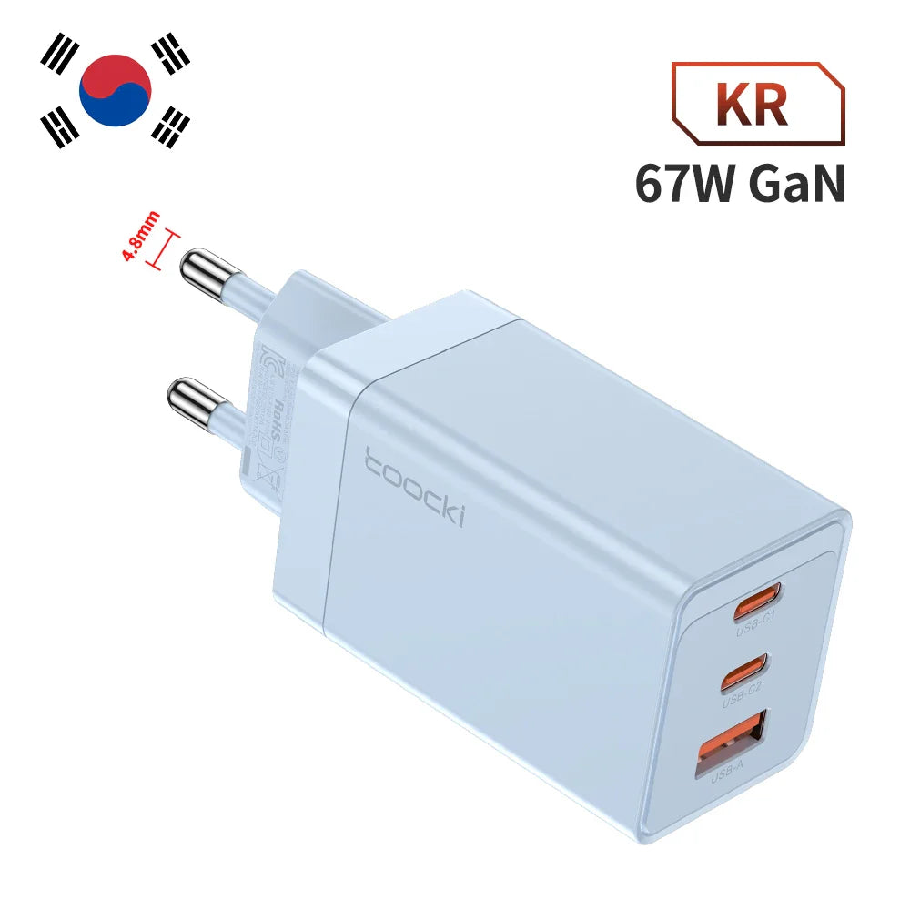 White 67W GaN charger with three USB ports and a South Korean plug.