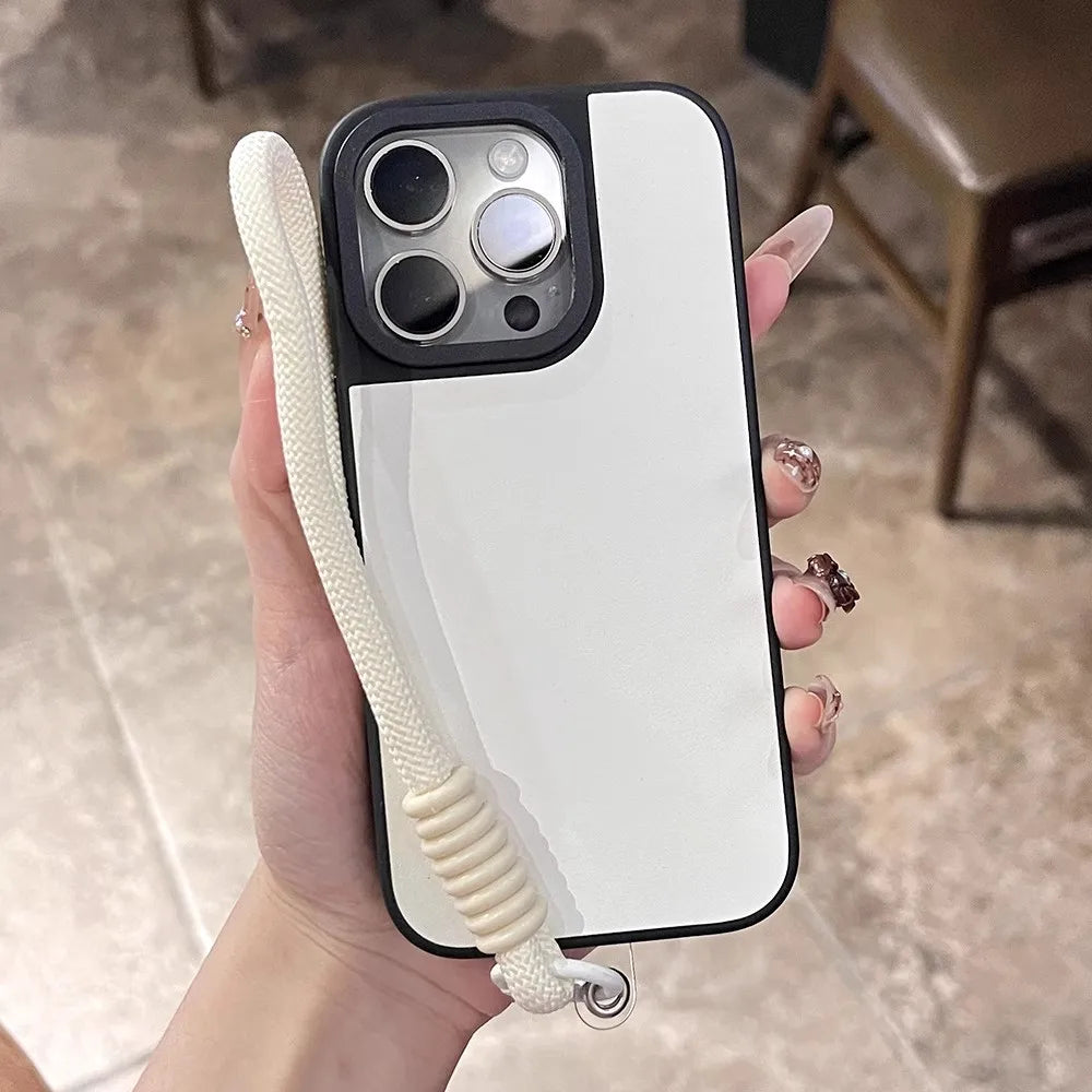White and black phone case with wrist strap.