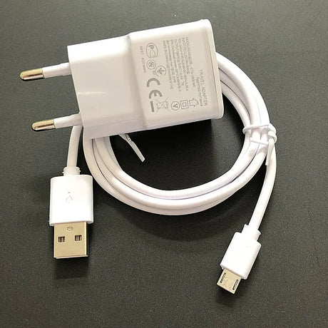 a close up of a white charger and a white cord on a table