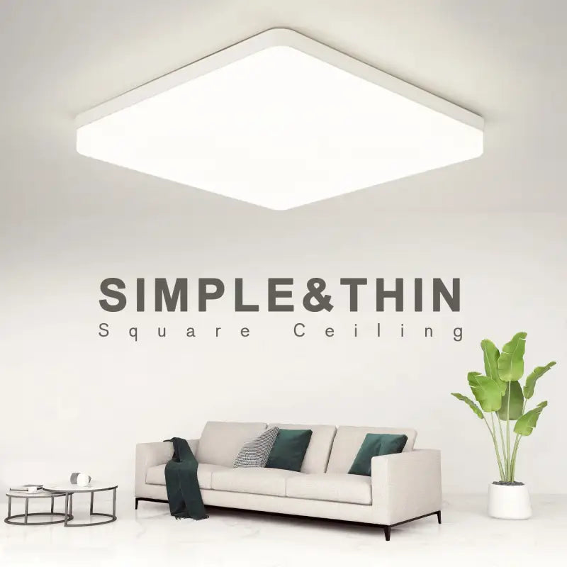 A white couch sitting in front of a white wall