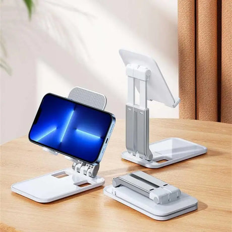 a desk with a phone and a laptop on it