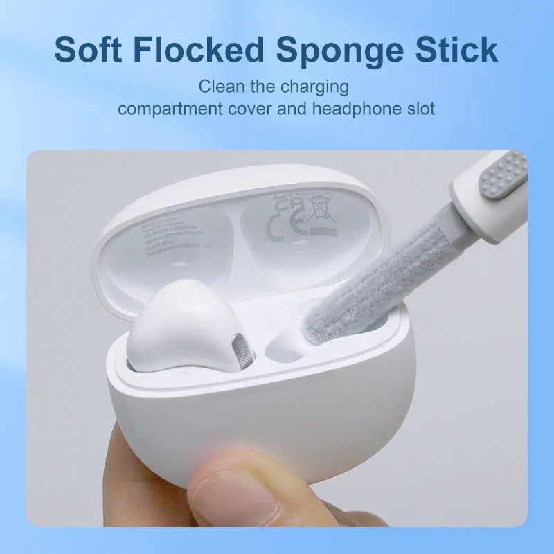 White earbud charging case with a cleaning tool inserted.