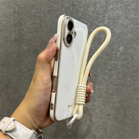 White and gold phone case with wrist strap.