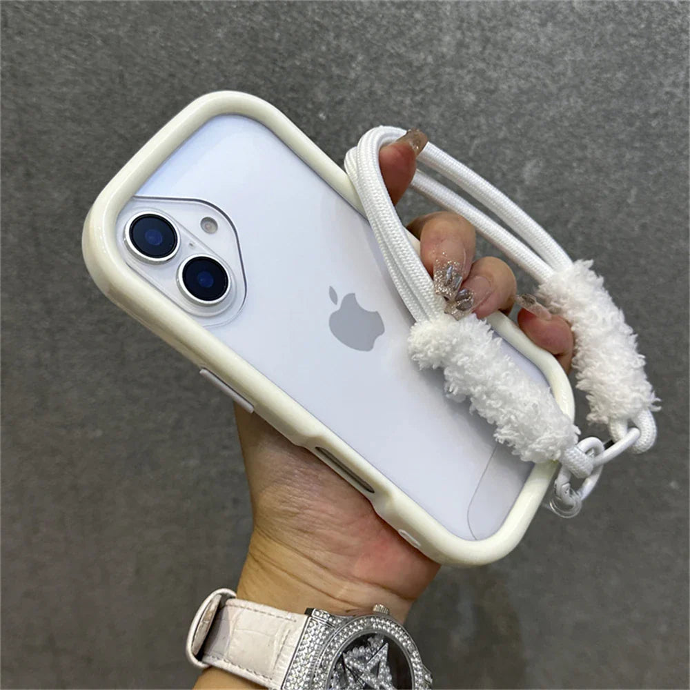White iPhone in a cushioned case with a fluffy strap.