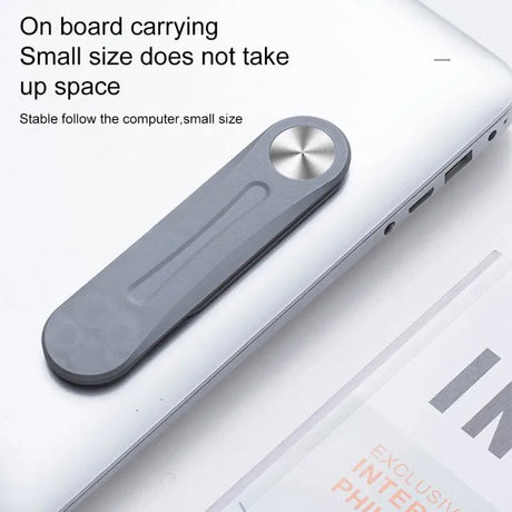 a laptop with a small device on top of it