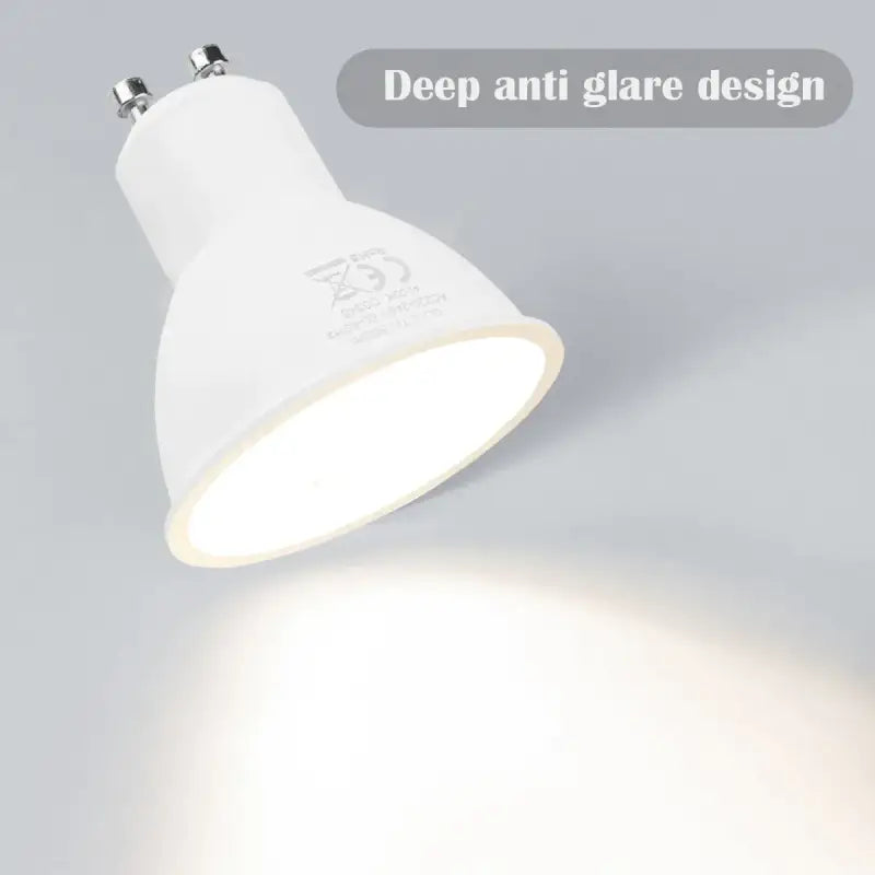 A white light bulb on a gray background