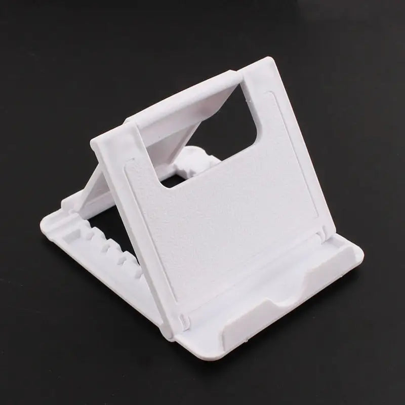 a white plastic phone holder on a black background