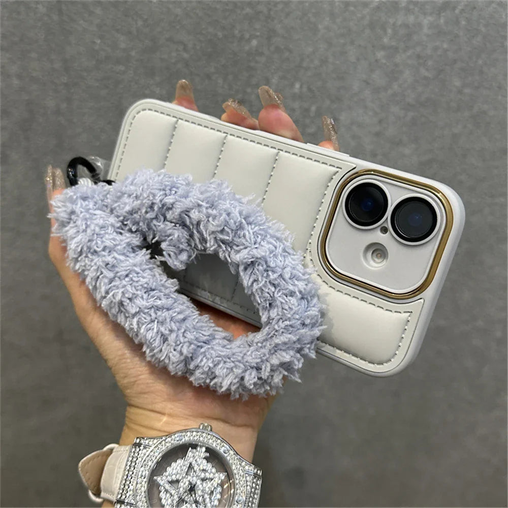 White quilted phone case with fuzzy wrist strap.