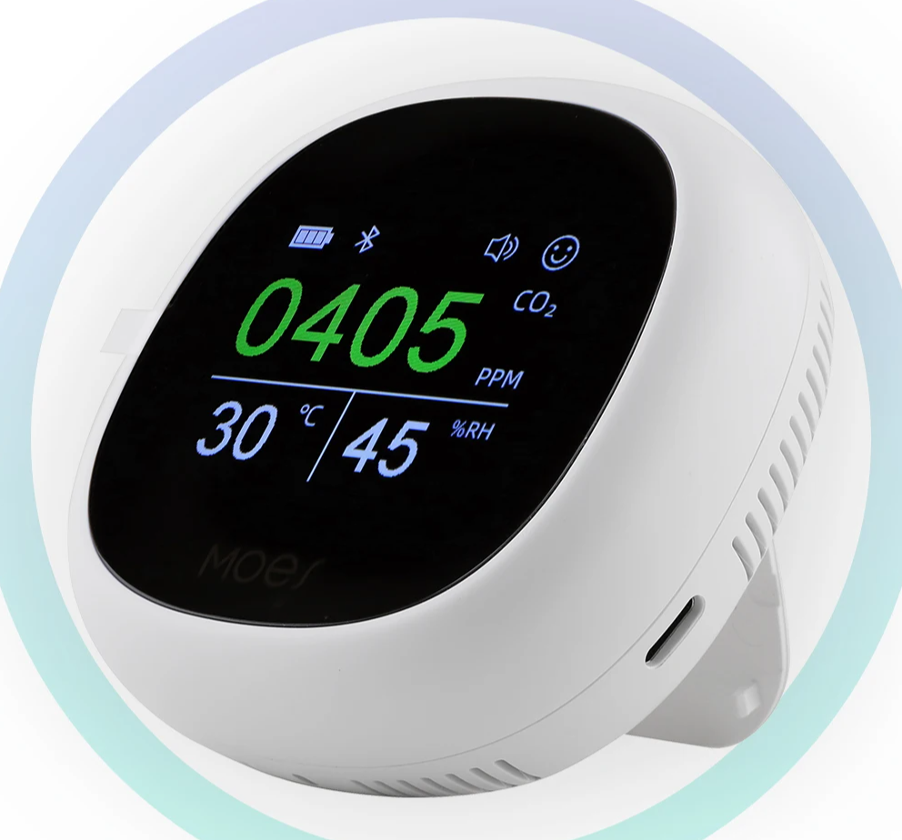 White, round, digital air quality monitor.