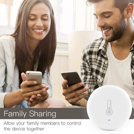 White, round smart home device with thermometer icon.