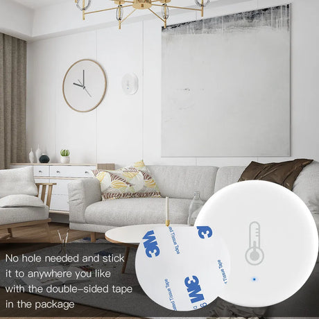 White round thermometer with adhesive tape.