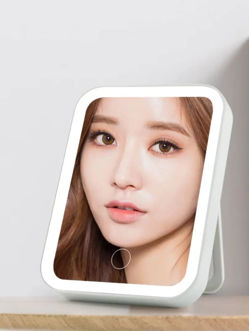 a white square mirror with a girl’s face