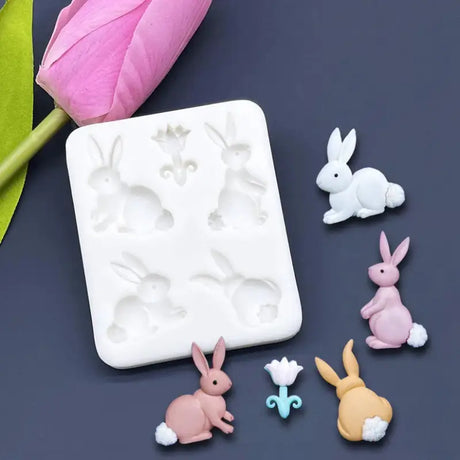 a white square soap dish with a pink tuffly flower and a small white rabbit