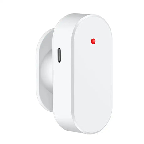 a white wall mounted device with a red button on it