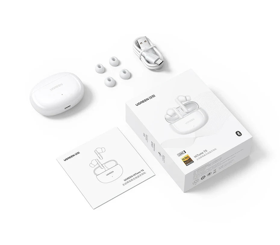 White wireless earbuds with accessories.