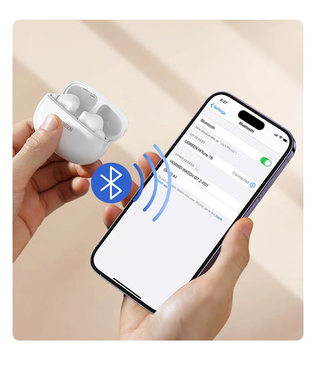 White wireless earbuds with charging case connected to a smartphone via Bluetooth.