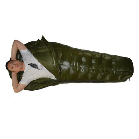 a man laying on a sleeping bag