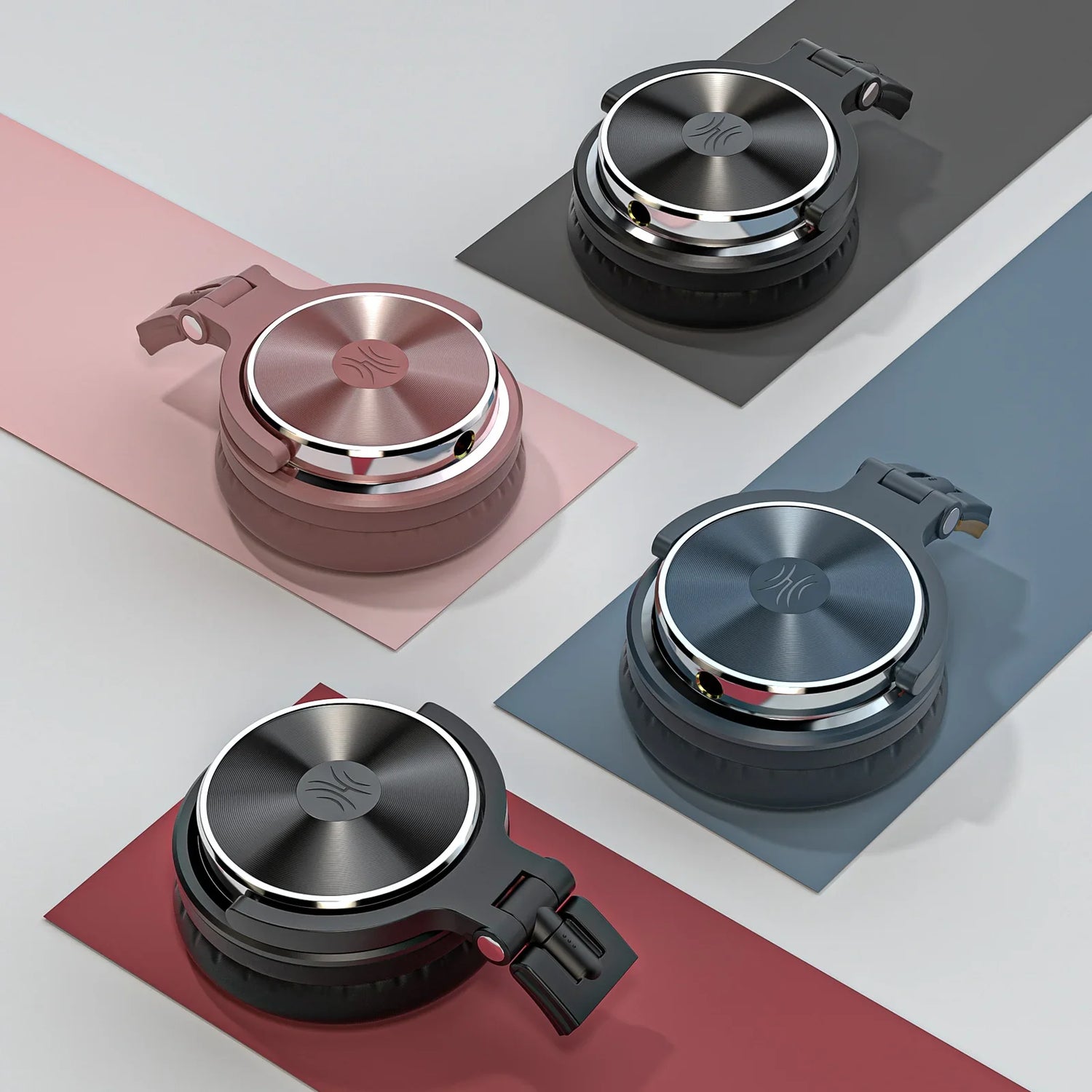 Wireless headphones or earbuds in various colors with metallic circular control surfaces.