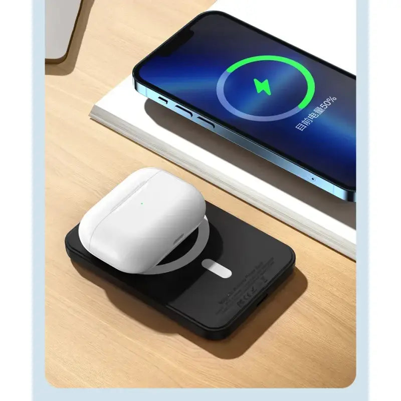 a wireless mouse on a desk next to a phone