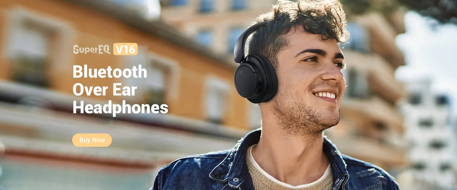 Wireless over-ear headphones worn by a smiling young man outdoors.