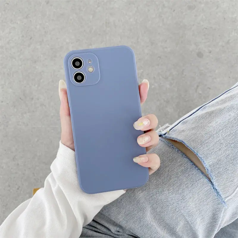 a woman holding a blue iphone case