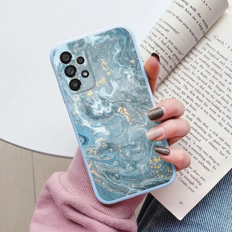 a woman holding a book and a phone case