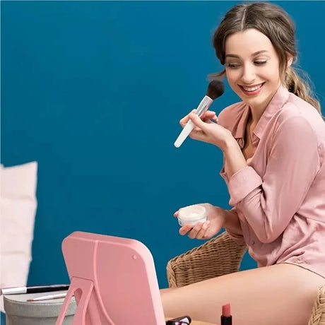 a woman sitting on a chair with a brush in her hand