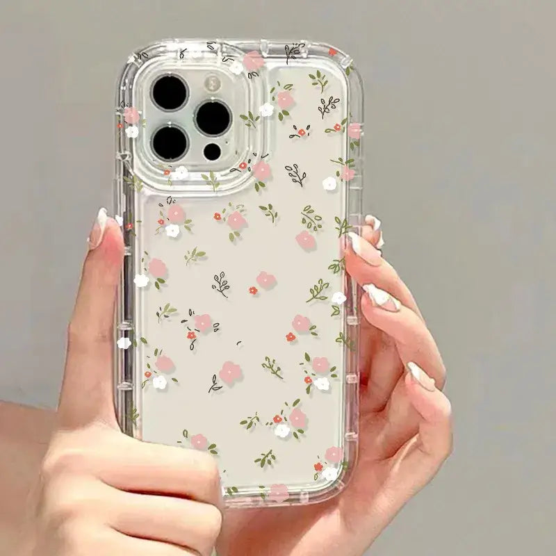 A woman holding a clear case with pink flowers on it