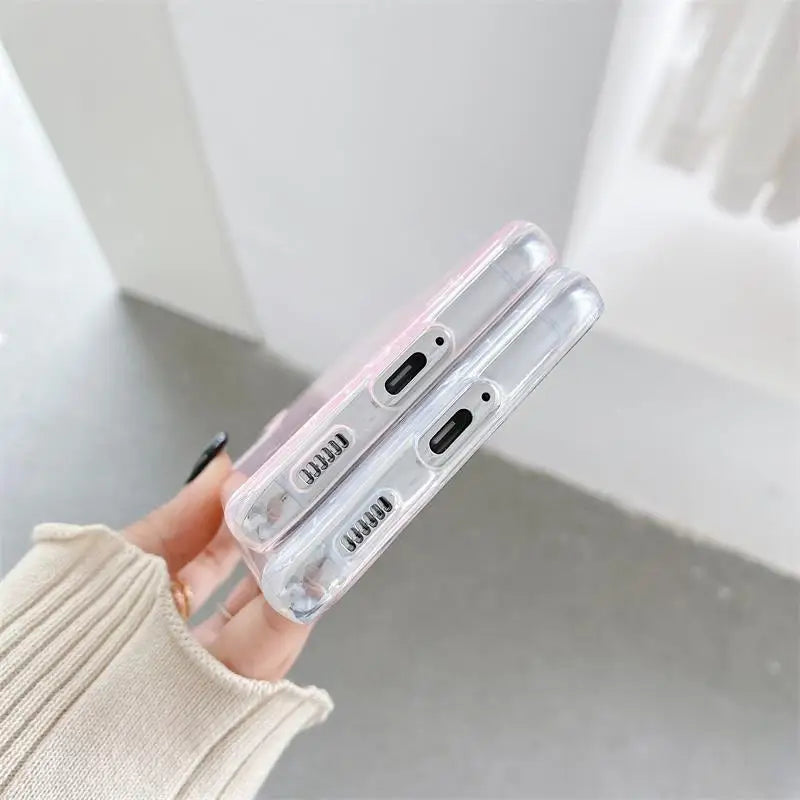 a woman holding a clear phone case