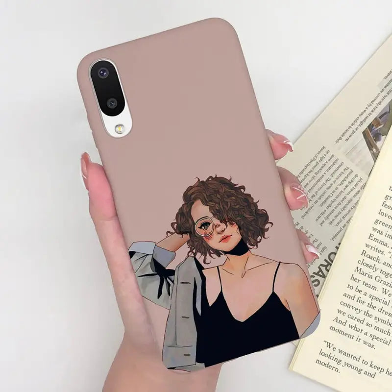 a woman holding a book and a phone case