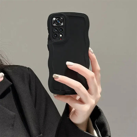 a woman holding a black phone case