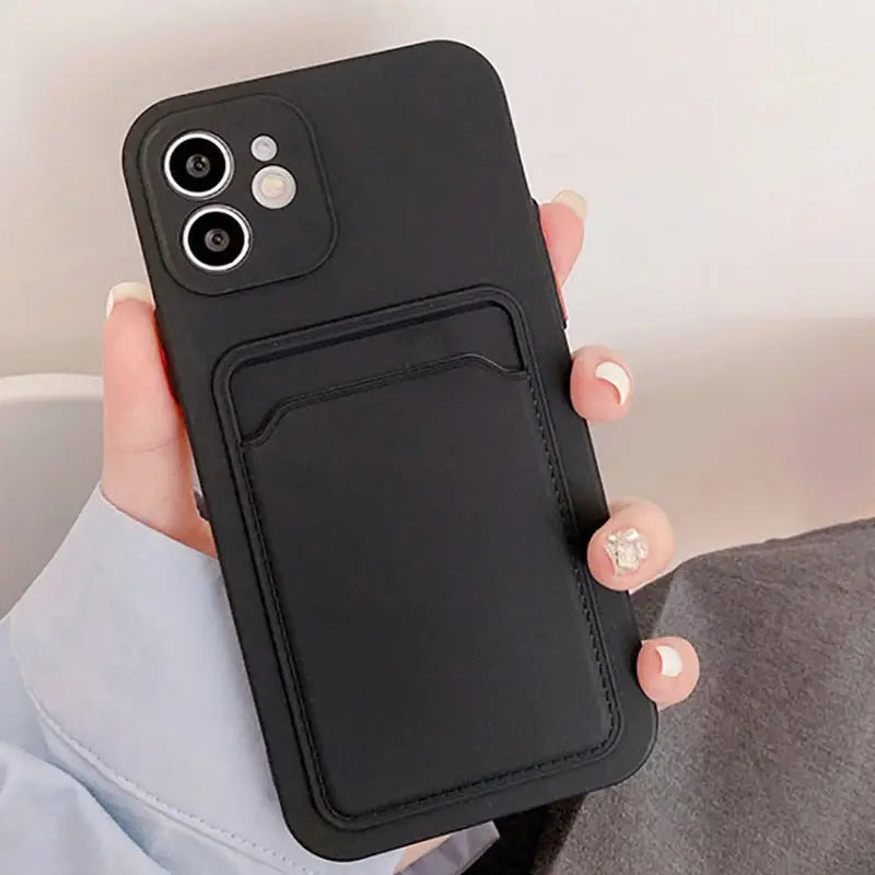 a woman holding a black phone case