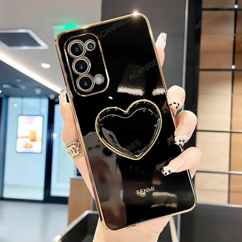 a woman holding a black phone with a heart on it