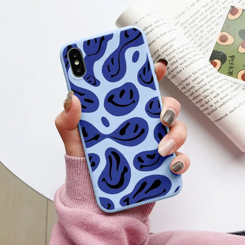 a woman holding a blue and black phone case