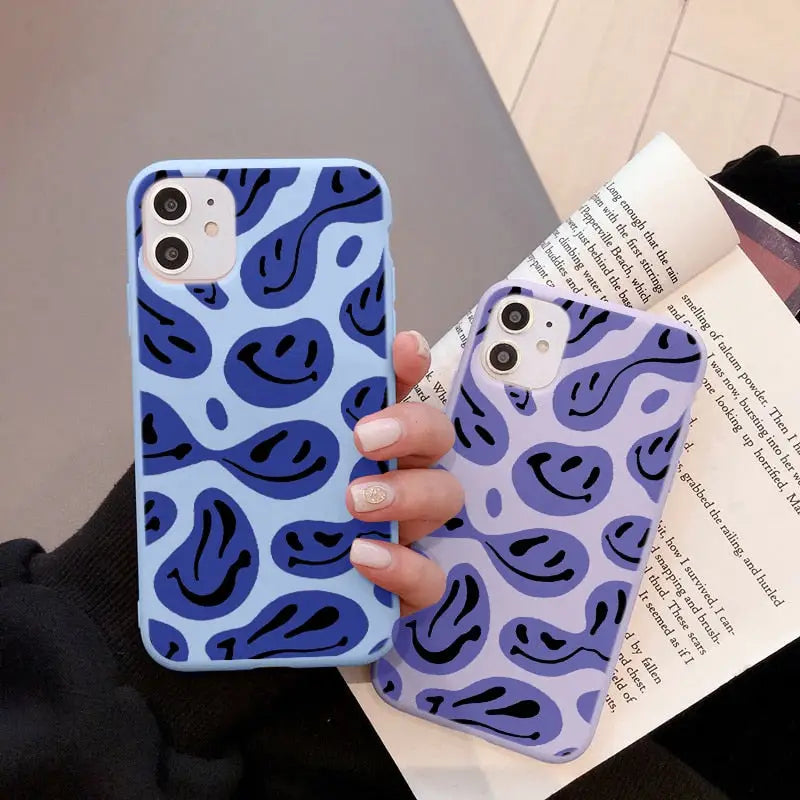 a woman holding a blue and purple camouflage print case