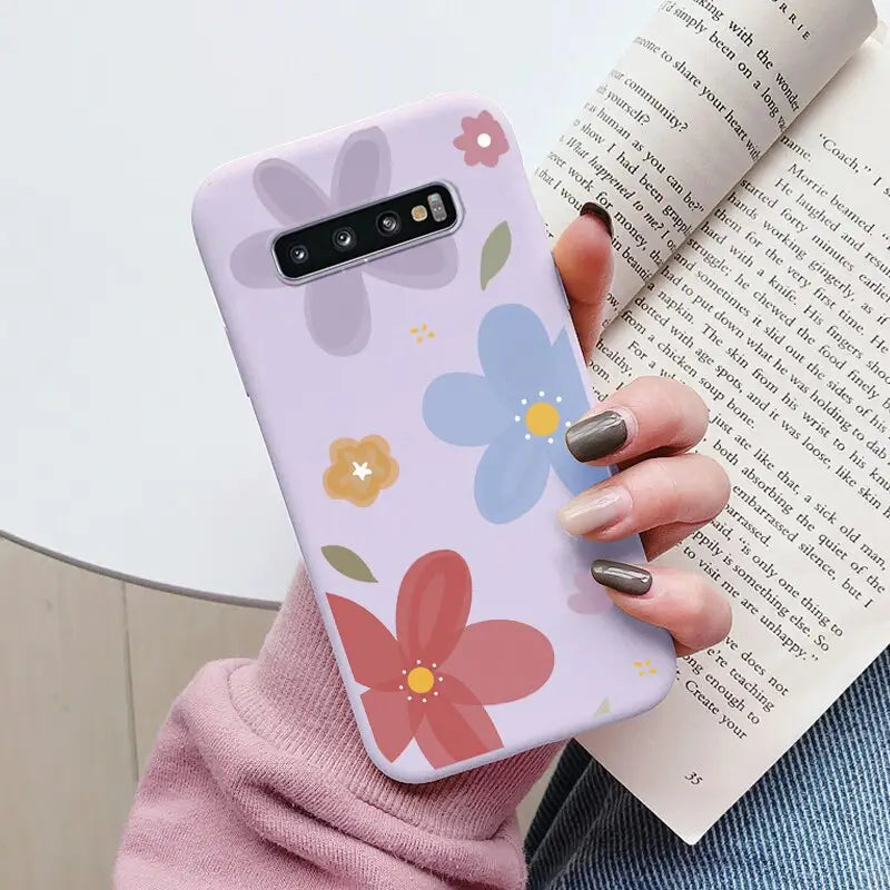 a woman holding a book and a phone case