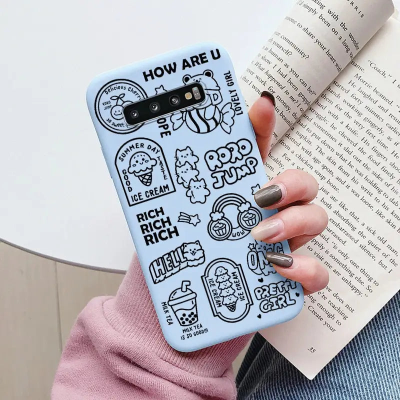 a woman holding a book and a phone case
