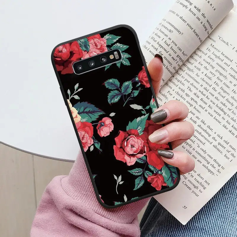 a woman holding a book and a phone case