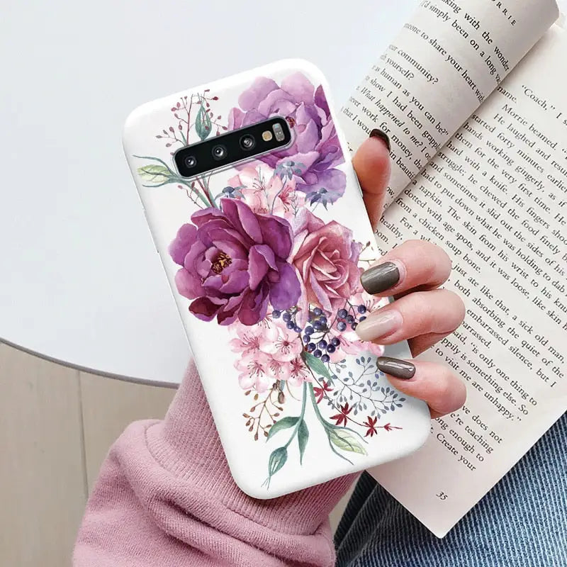 a woman holding a book and a phone case