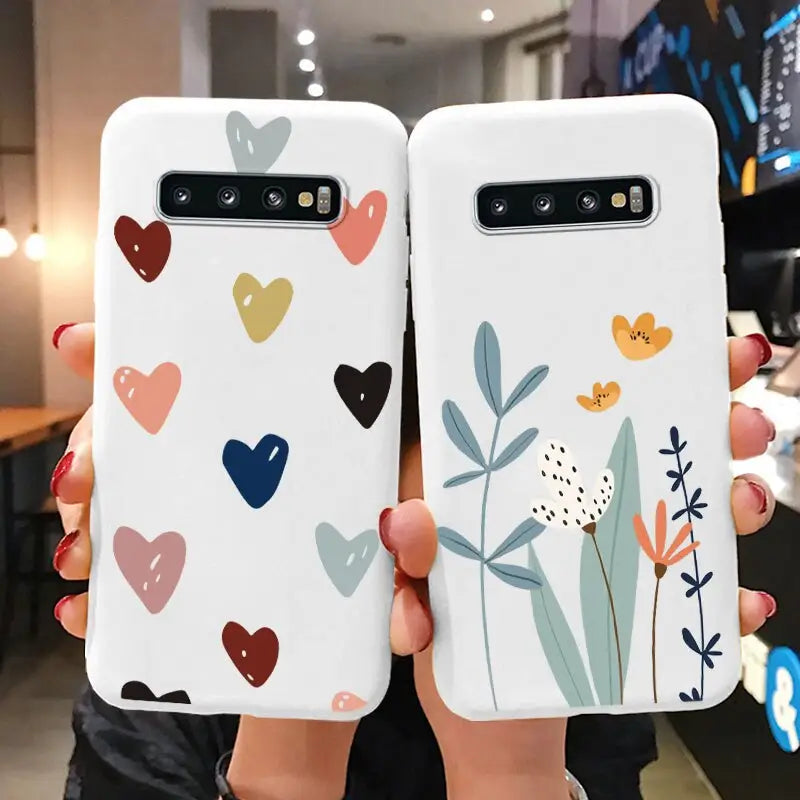 two phone cases with hearts and flowers