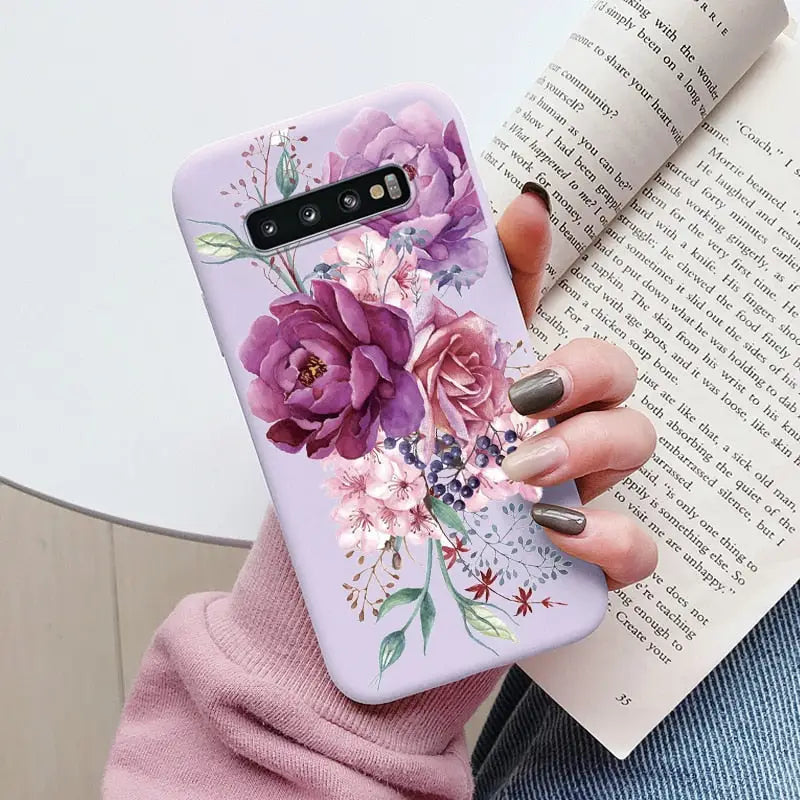 a woman holding a book and a phone case