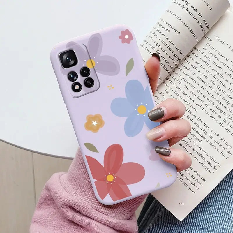 a woman holding a book and a phone case