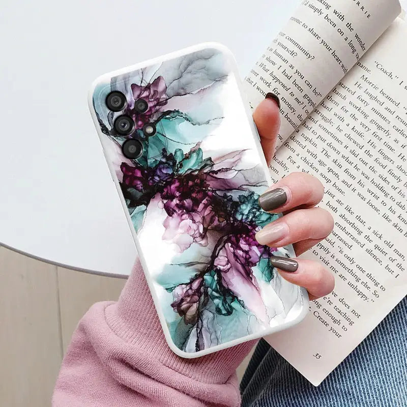 a woman holding a book and a phone case